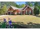 Beautiful brick home featuring a well-manicured lawn and a two-car garage at 1315 Badingham Dr, Cumming, GA 30041