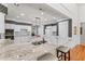 Bright kitchen offers granite countertops, island with bar seating, white cabinetry and ample space at 1315 Badingham Dr, Cumming, GA 30041
