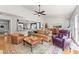 Bright and airy living room featuring hardwood floors, stylish furniture, and an open layout with a kitchen view at 1315 Badingham Dr, Cumming, GA 30041