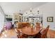 Open concept living space features a fireplace, built-ins, and seamless flow into the kitchen and dining area at 1315 Badingham Dr, Cumming, GA 30041