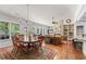 Bright living space with large windows, fireplace, built-ins, dining table, and seamless flow at 1315 Badingham Dr, Cumming, GA 30041
