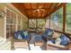 Relaxing screened porch with wicker furniture, a ceiling fan, and a view of the wooded back yard at 1315 Badingham Dr, Cumming, GA 30041