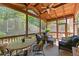 Inviting screened porch with outdoor furniture, a wood ceiling, and a view of the trees at 1315 Badingham Dr, Cumming, GA 30041