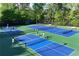 People are playing tennis in this overhead view of a neighborhood tennis court at 1315 Badingham Dr, Cumming, GA 30041