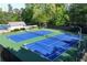 Aerial view shows neighborhood tennis courts where players are enjoying a match at 1315 Badingham Dr, Cumming, GA 30041