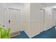Inviting hallway featuring neutral walls, blue carpet, and stylish trim detail at 6851 Roswell Rd # B15, Sandy Springs, GA 30328