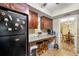 Bright kitchen features dark wood cabinetry, granite countertops, and is open to the breakfast nook at 6851 Roswell Rd # B15, Sandy Springs, GA 30328