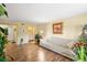 Open living room featuring wood floors, a comfortable couch, and warm lighting at 6851 Roswell Rd # B15, Sandy Springs, GA 30328