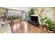 Airy living room with wood floors, a large window, and an open doorway to the outdoors at 6851 Roswell Rd # B15, Sandy Springs, GA 30328