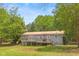 Charming home with a wooden deck and lush green surroundings at 928 Rocky Creek Rd, Hampton, GA 30228