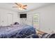 Bright bedroom with a ceiling fan, access to the backyard, and closet at 928 Rocky Creek Rd, Hampton, GA 30228