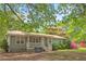 Exterior of a charming single story home with a metal roof, a front porch, and a well-maintained lawn at 928 Rocky Creek Rd, Hampton, GA 30228