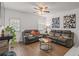 Cozy living room featuring hardwood floors, ample seating, and natural light from the window at 928 Rocky Creek Rd, Hampton, GA 30228