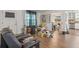 Spacious living room featuring hardwood floors, neutral paint, and an open floor plan connecting to the dining and kitchen at 928 Rocky Creek Rd, Hampton, GA 30228