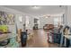 Spacious living room featuring hardwood floors, neutral paint, and an open floor plan connecting to the kitchen at 928 Rocky Creek Rd, Hampton, GA 30228