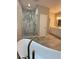 Elegant bathroom featuring a soaking tub and glass-enclosed shower with marble accents at 169 Long Dr, Marietta, GA 30060