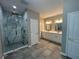 Bathroom featuring a large glass-enclosed shower with marble accents and double vanity at 169 Long Dr, Marietta, GA 30060
