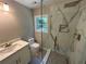 Modern bathroom featuring a white vanity and a glass-enclosed shower with white marble-patterned walls at 169 Long Dr, Marietta, GA 30060