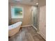 Spa-like bathroom with soaking tub and walk-in shower with glass door at 169 Long Dr, Marietta, GA 30060