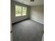 An empty, carpeted bedroom with natural light streaming in through the windows at 169 Long Dr, Marietta, GA 30060