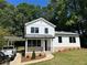 Charming two-story home with white siding, modern windows and a covered carport and manicured front yard at 169 Long Dr, Marietta, GA 30060