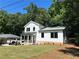Stylish two-story home boasts white siding, black-framed windows, and freshly landscaped front yard on a sunny day at 169 Long Dr, Marietta, GA 30060