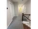 A brightly lit hallway with light gray walls and carpet leads to other rooms in the house at 169 Long Dr, Marietta, GA 30060