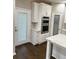 Contemporary kitchen featuring stainless double ovens, a walk-in pantry, and marble countertops on the center island at 169 Long Dr, Marietta, GA 30060