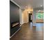 Modern living space features a sleek fireplace, hardwood floors, and a view into the kitchen and dining area at 169 Long Dr, Marietta, GA 30060