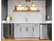 Basement bar with white countertop, gray cabinets, stainless steel appliances, and tile backsplash at 2152 Tourney Dr, Marietta, GA 30062