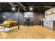 Finished basement featuring exposed ceiling, vinyl floors, modern furniture, and a bar at 2152 Tourney Dr, Marietta, GA 30062