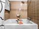 Tiled bathtub with white fixtures and brown square tiling at 2152 Tourney Dr, Marietta, GA 30062