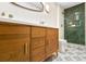 Bathroom with wood vanity, modern fixtures and textured tile shower at 2152 Tourney Dr, Marietta, GA 30062