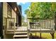 Wooden deck with railing offers an outdoor seating area surrounded by lush trees at 2152 Tourney Dr, Marietta, GA 30062