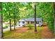 Charming white ranch-style home boasts a lovely front yard with mature trees at 2152 Tourney Dr, Marietta, GA 30062