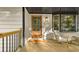 Welcoming front porch with a wooden door, cozy seating, and a view of the serene surroundings at 2152 Tourney Dr, Marietta, GA 30062