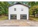 Detached two-car garage with dark doors and concrete driveway at 2152 Tourney Dr, Marietta, GA 30062