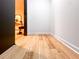 Hallway with wood floors, white trim, and view into a room beyond the doorway at 2152 Tourney Dr, Marietta, GA 30062