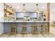Stylish kitchen bar with wooden stools, pendant lighting, and stainless steel appliances at 2152 Tourney Dr, Marietta, GA 30062
