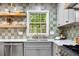 Beautiful kitchen with stylish backsplash, stainless steel appliances and a window view at 2152 Tourney Dr, Marietta, GA 30062