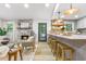 Modern kitchen with stone fireplace view, a breakfast bar with seating, and stainless steel appliances at 2152 Tourney Dr, Marietta, GA 30062