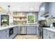 Updated kitchen featuring gray cabinets, stainless steel appliances, and stylish backsplash at 2152 Tourney Dr, Marietta, GA 30062