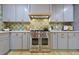 Modern kitchen featuring stainless steel appliances, grey cabinetry and stylish backsplash at 2152 Tourney Dr, Marietta, GA 30062