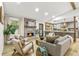 Open living area featuring a stone fireplace, wood floors, and seamless flow to the kitchen at 2152 Tourney Dr, Marietta, GA 30062