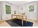 Office with hardwood floors, modern desk, neutral paint, and natural light from two windows at 2152 Tourney Dr, Marietta, GA 30062