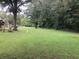 Expansive backyard with lush green lawn surrounded by mature trees at 2617 Terrace Pkwy, Morrow, GA 30260