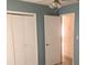 Simple bedroom featuring muted blue walls, carpeted floors, and a closet at 2617 Terrace Pkwy, Morrow, GA 30260