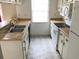 A clean, outdated kitchen features white appliances, laminate countertops, and overhead cabinets at 2617 Terrace Pkwy, Morrow, GA 30260