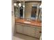 Cozy bathroom with a single-sink vanity with a decorative countertop and plenty of mirror space at 3358 Stonecrest Ct, Atlanta, GA 30341