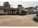 Charming brick home with a stone chimney and dormant landscaping in a suburban neighborhood at 3358 Stonecrest Ct, Atlanta, GA 30341
